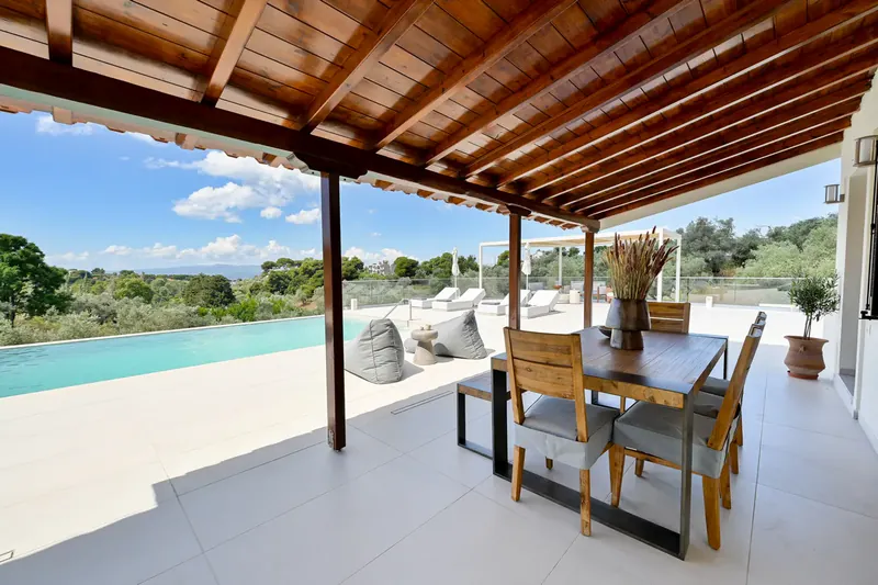 The outdoor dining table under the timber pergola
